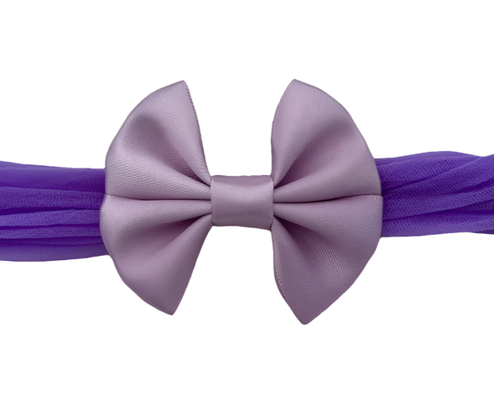 Purple headband with a large bow on a white background