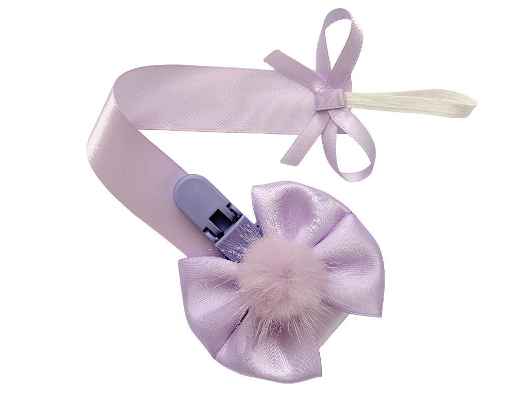 Lavender hair clip with bow and fluffy detail on a white background