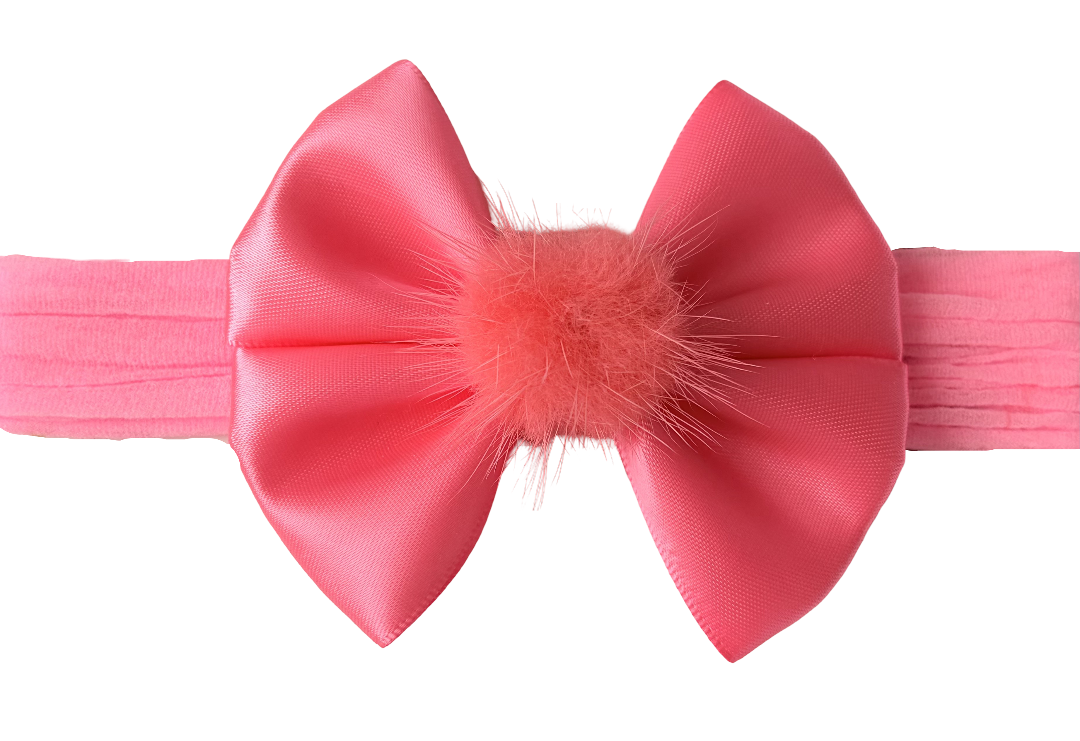Pink headband with a large bow on a white background