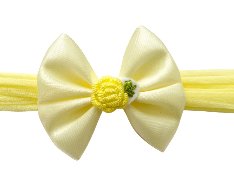 Yellow headband with a bow on a white background
