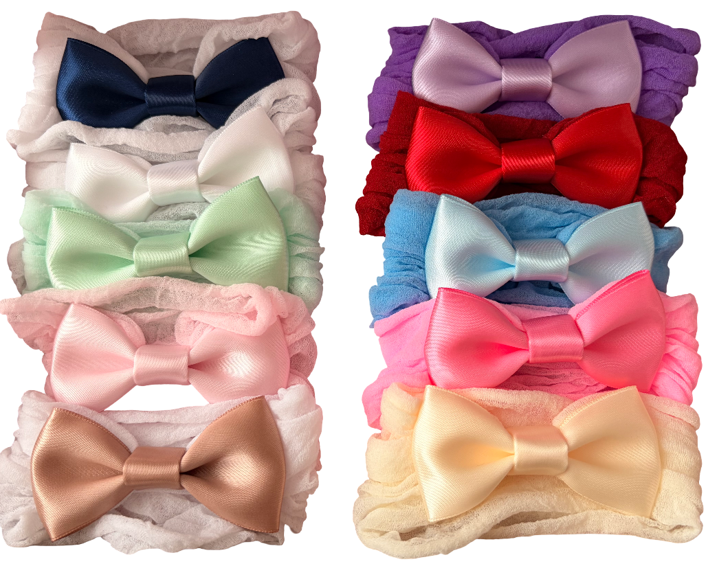 Set of colorful bow hair accessories on a white background