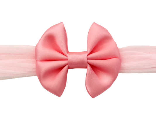 Pink bow headband on a white background