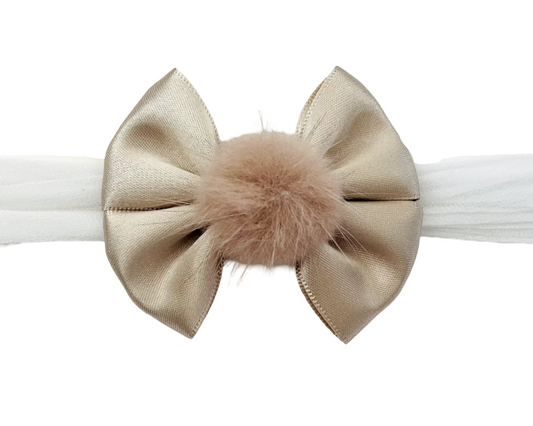 Beige bow headband with a fluffy center on a white background