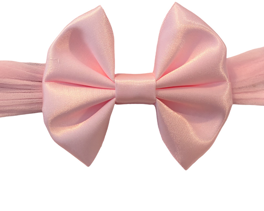 A light pink satin bow tie with matching pink pleated elastic bands on each side, shown against a plain white background.