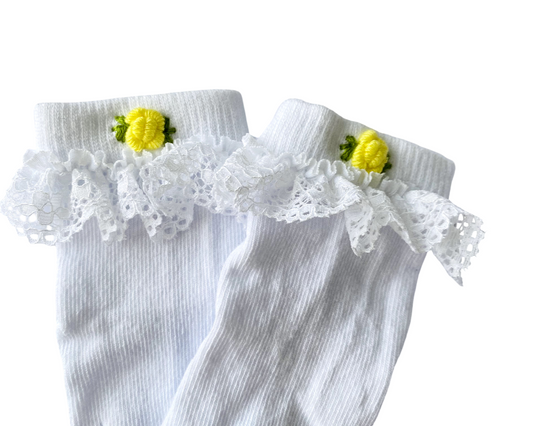 White socks with lace and yellow flower details on a white background