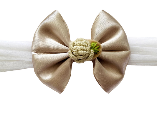 Beige bow hair clip on a white background