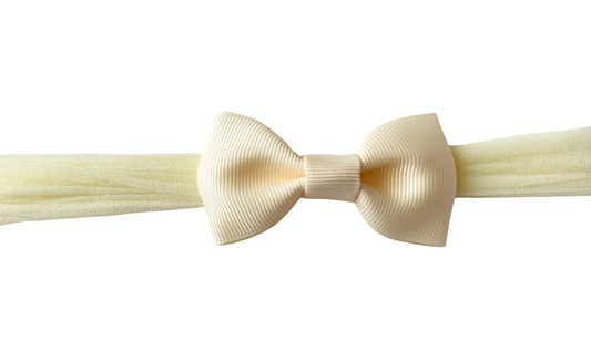 Cream-colored bow tie on a white background