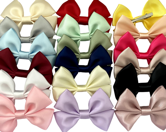 Collection of colorful hair bows on a white background