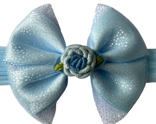 Light blue bow hair accessory on a white background