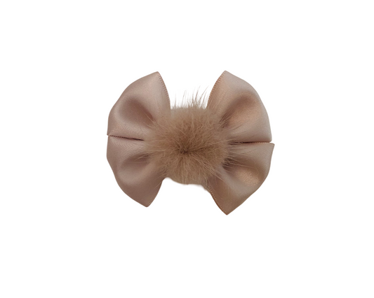 Beige bow hair clip with fur center on a white background