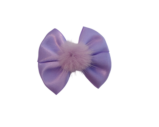 Purple bow with a fluffy pom-pom on a white background