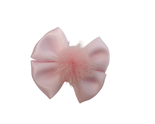 Pink bow with feathers on a white background