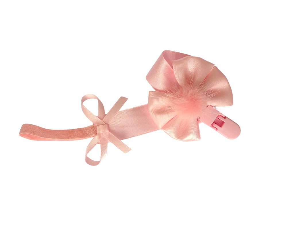 Pink ballet slipper with bow on a white background