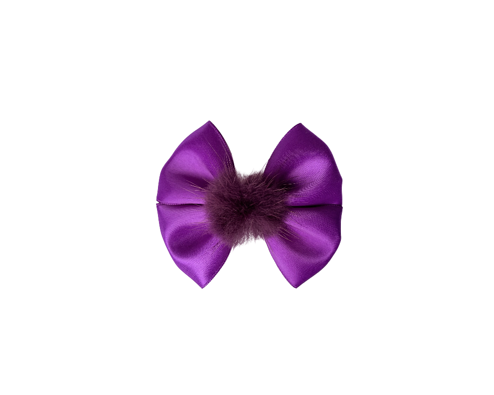 Purple bow with a brown center on a white background